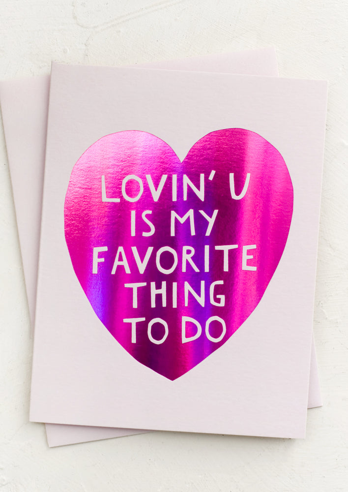 A card with metallic pink heart reading "Lovin' U Is My Favorite Thing To Do".