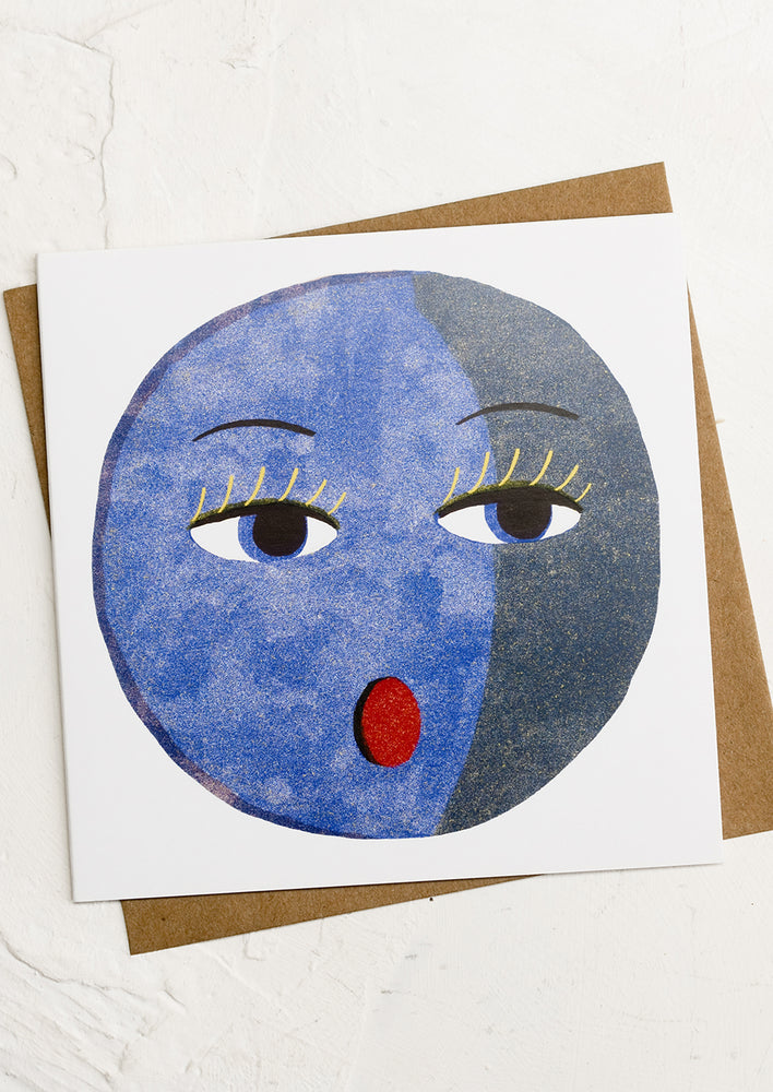 1: A square greeting card with illustration of blue moon with face.