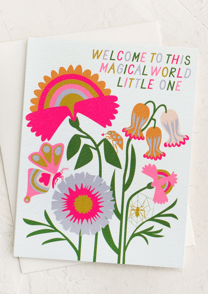 A neon floral print card reading "Welcome to this magical world little one".