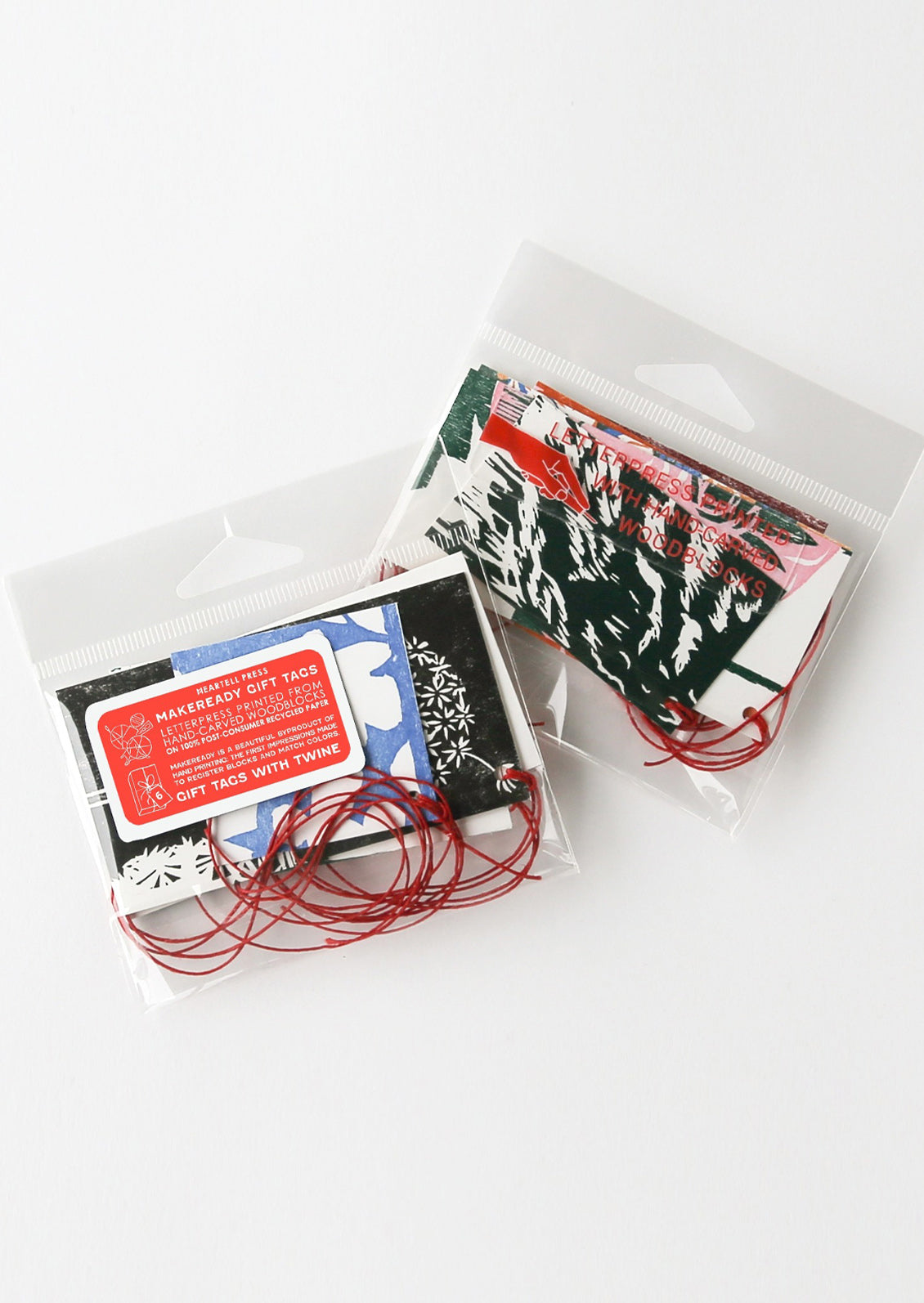 Two small packages with colorful labels on a white background