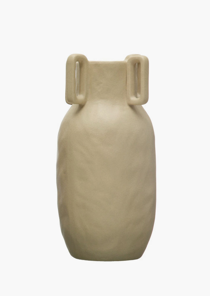 A sand color vase in matte ceramic with decorative square handle detail around mouth.