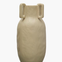 3: A sand color vase in matte ceramic with decorative square handle detail around mouth.