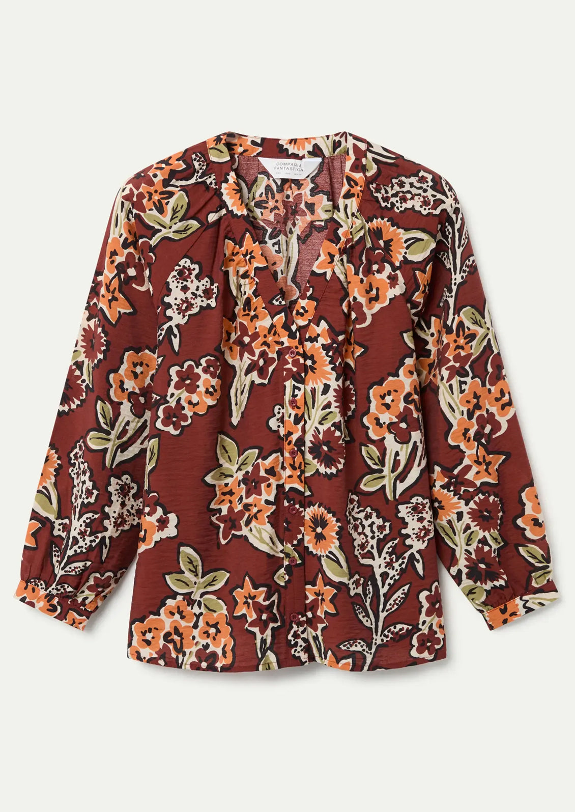 A floral print long sleeve blouse in rust with orange floral pattern.