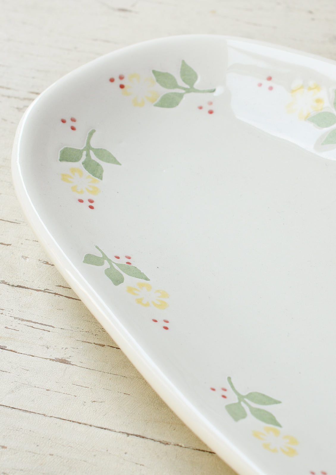 A long oval ceramic planter with yellow marigolds around the edge.