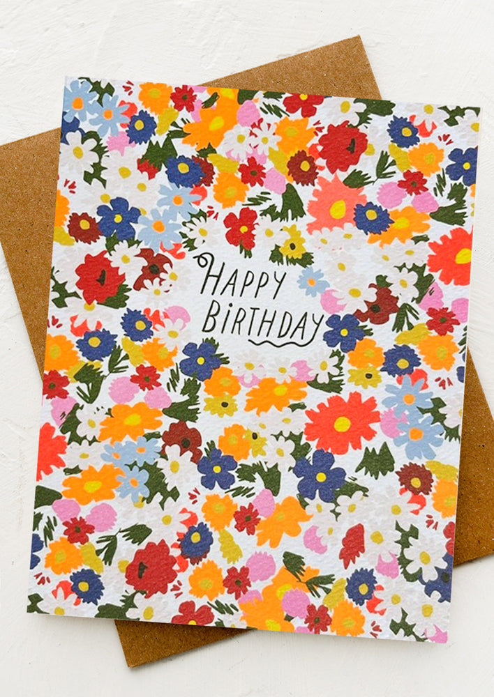 A colorful floral print card reading "Happy Birthday".
