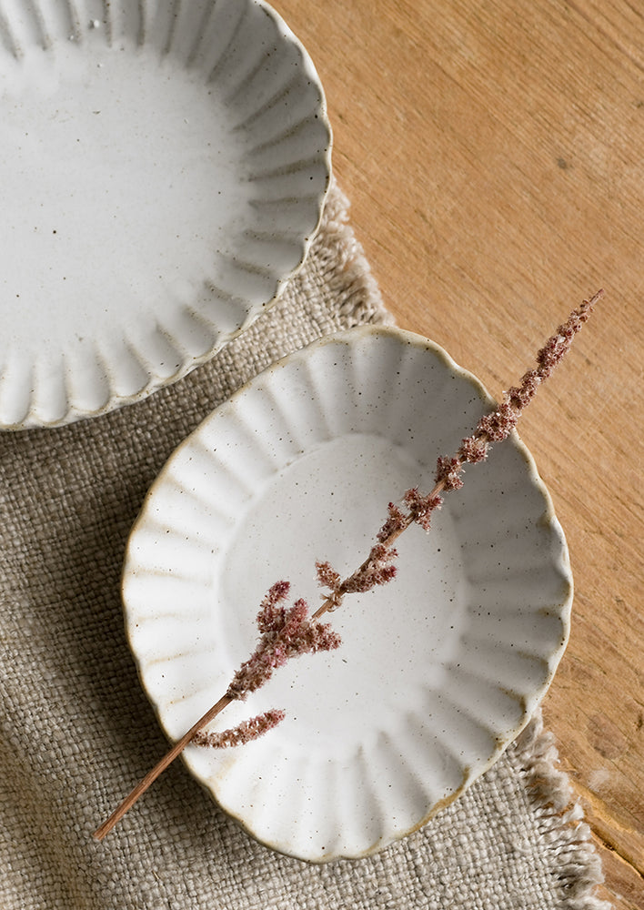 Pleated stoneware dishes in assorted shapes.