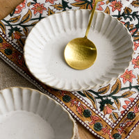 3: Dishes and gold spoon.