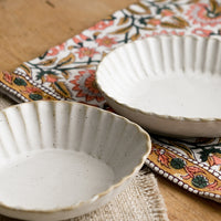 6: Pleated stoneware dishes in assorted shapes.