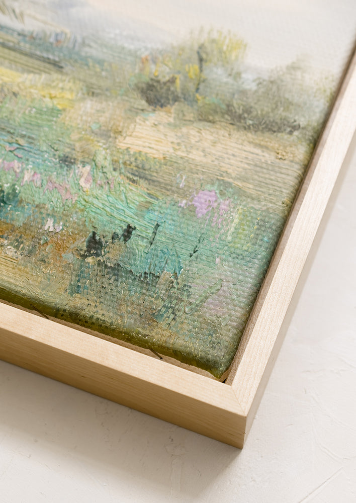 A framed original oil painting of colorful meadow, in natural wood frame.