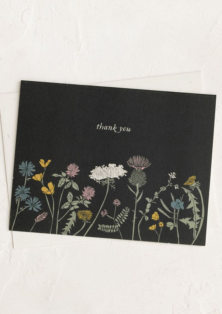 1: A black background thank you card with color floral print.