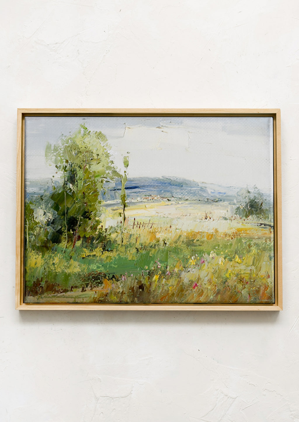 1: A framed original landscape painting of a meadow.