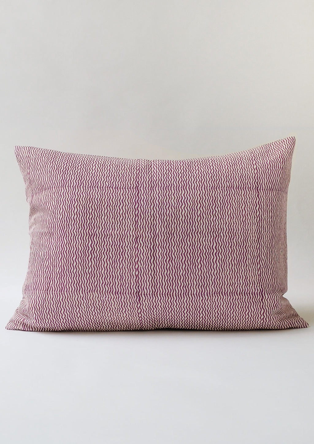 2: A lumbar throw pillow with wavy purple lines.