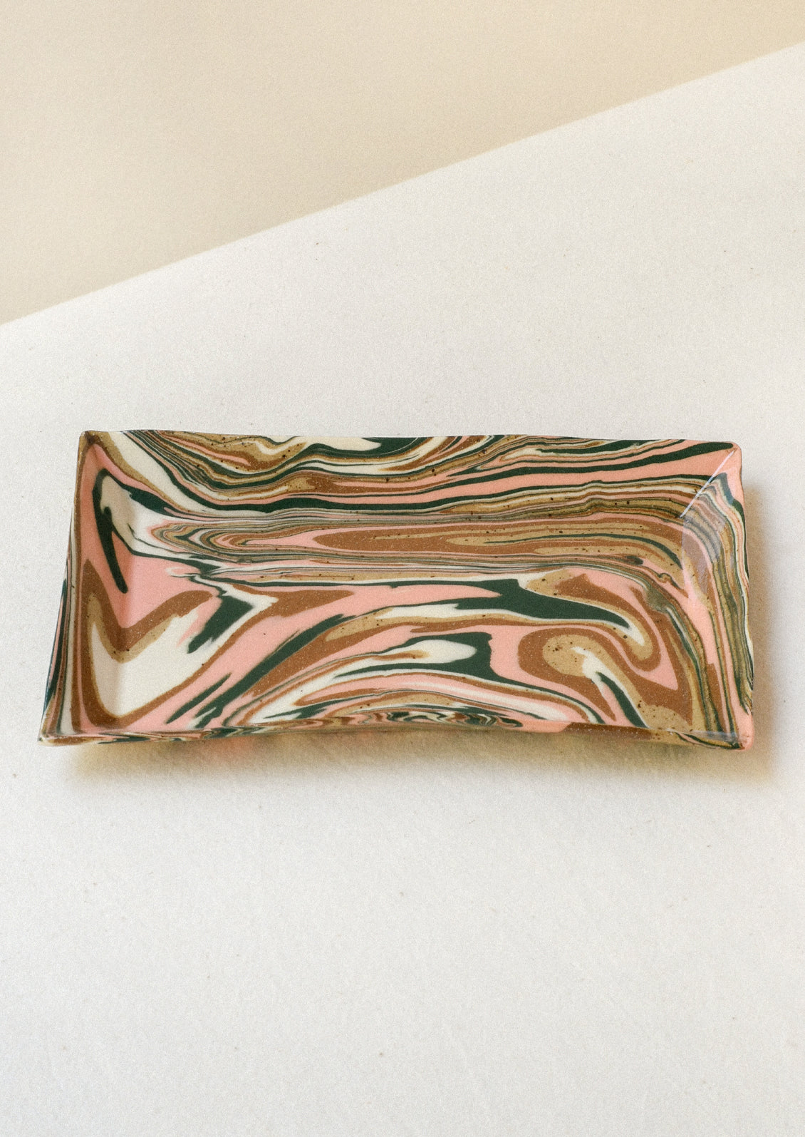 Handmade rectangular catchall tray with a pink, green and brown marble design.