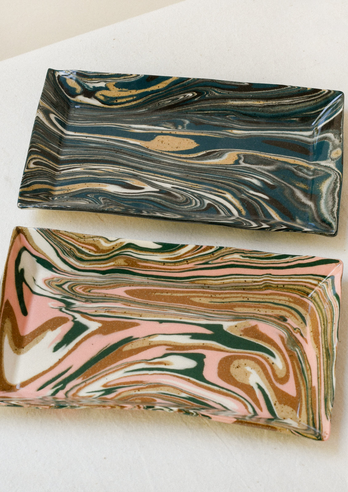 Handmade rectangular catchall trays with a colorful marble design.
