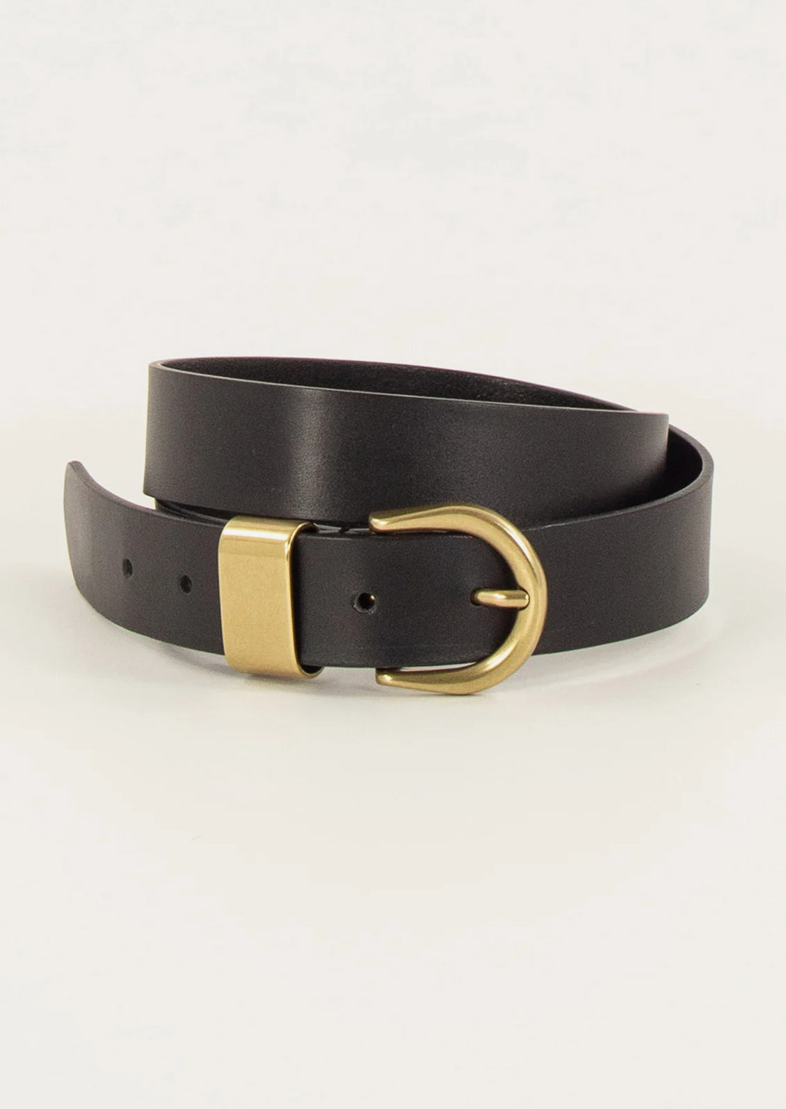 Black leather belt with a gold buckle on a light gray background