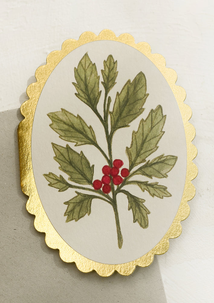 A scalloped mini card in oval shape with holly design.