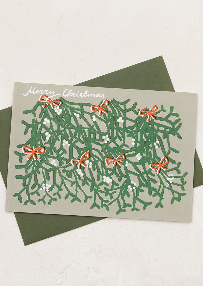 1: An illustrated card with mistletoe graphic and text reads "Merry Christmas".