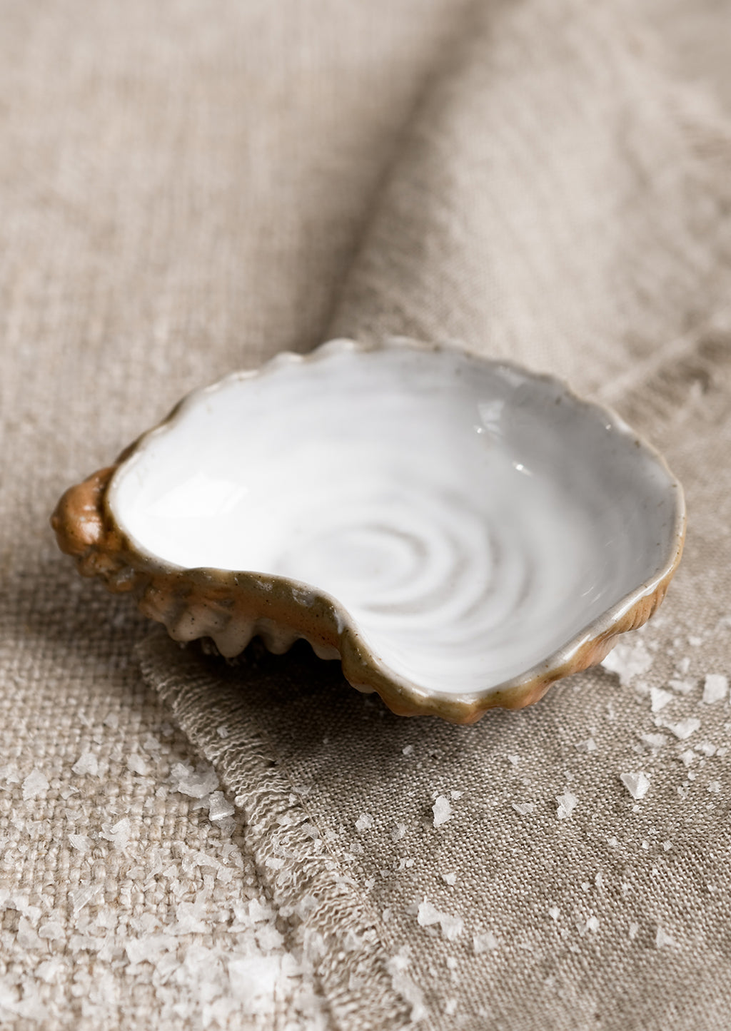 Mignonette Dish: A small ceramic serving dish in shape of an oyster shell.