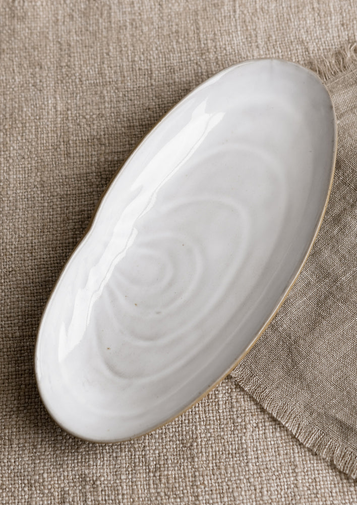 A ceramic serving platter in shape of a shell.