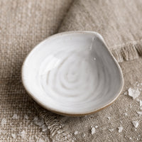 Salt Dish: A small ceramic serving dish in shape of a mussel shell.