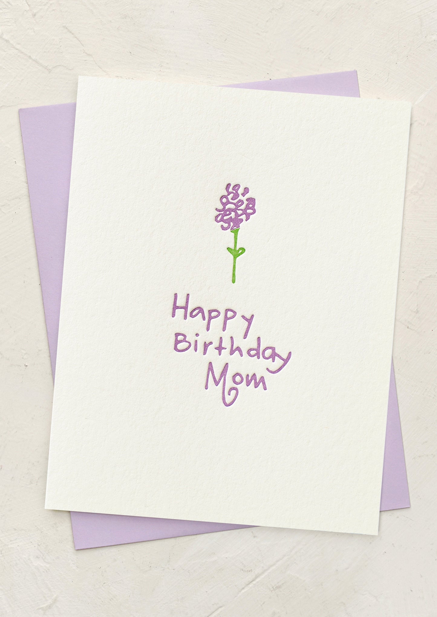 Greeting card with a purple flower illustration and 'Happy Birthday Mom' text on a white background.