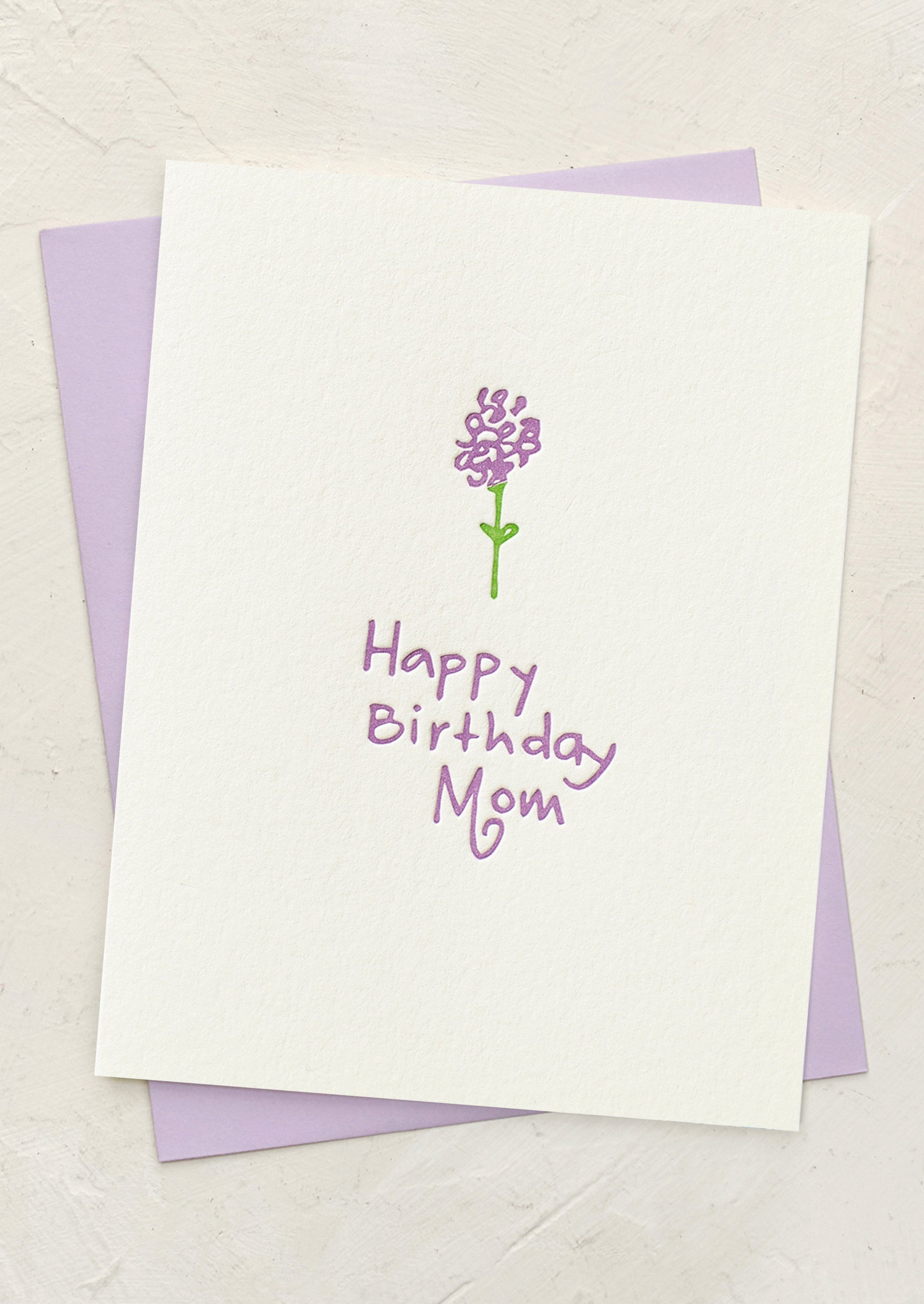 Greeting card with a purple flower illustration and 'Happy Birthday Mom' text on a white background.