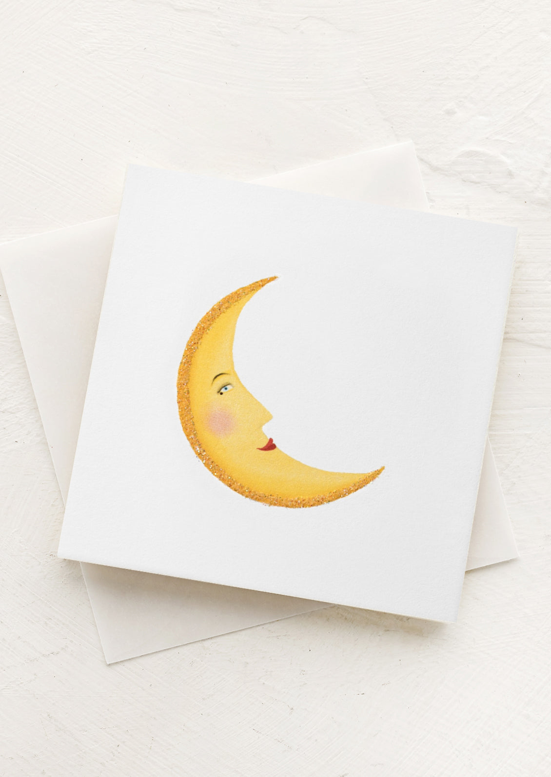 A small gift enclosure card with a smiling crescent moon design.