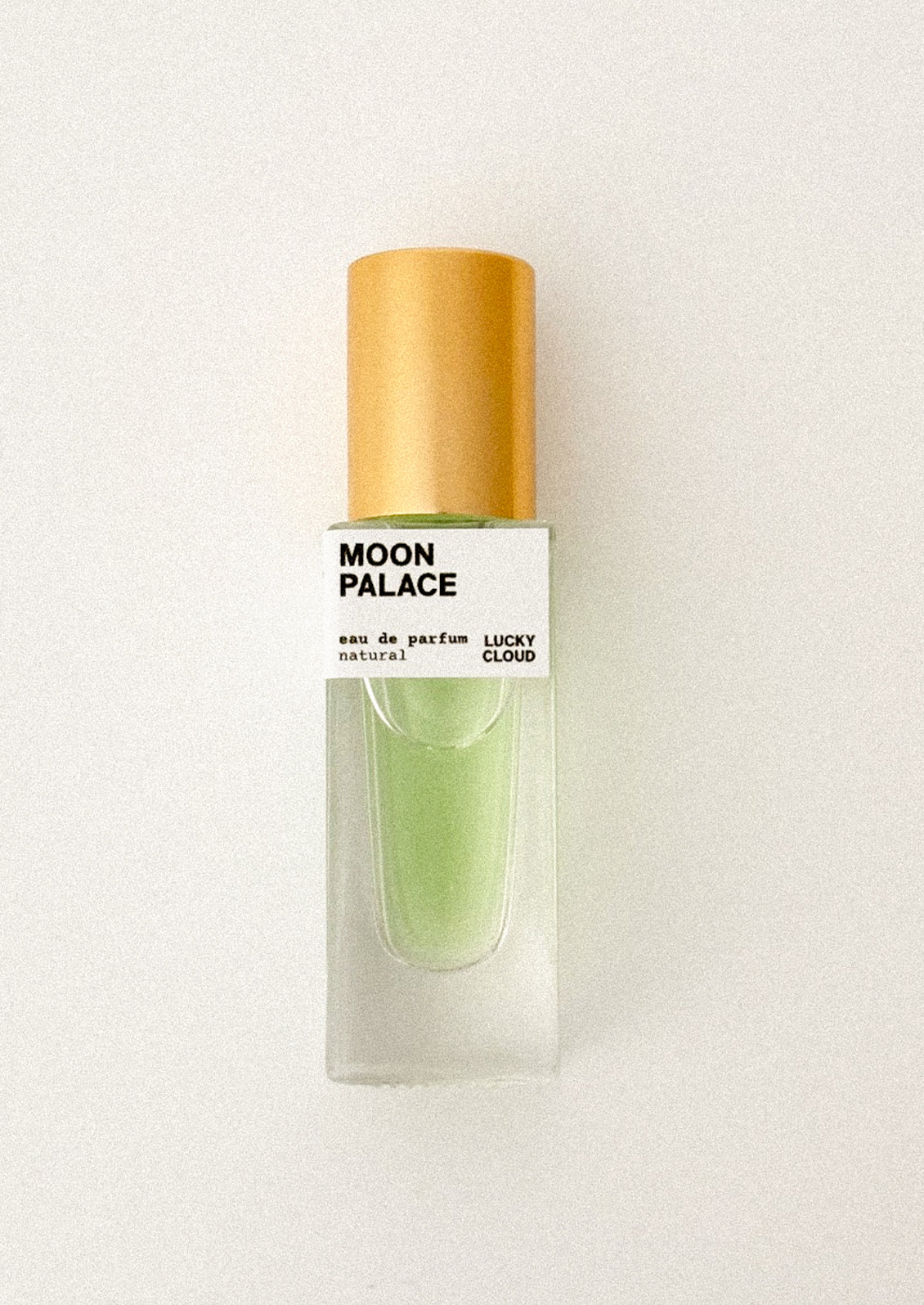 Perfume bottle labeled 'Moon Palace Lucky Cloud' on a white background