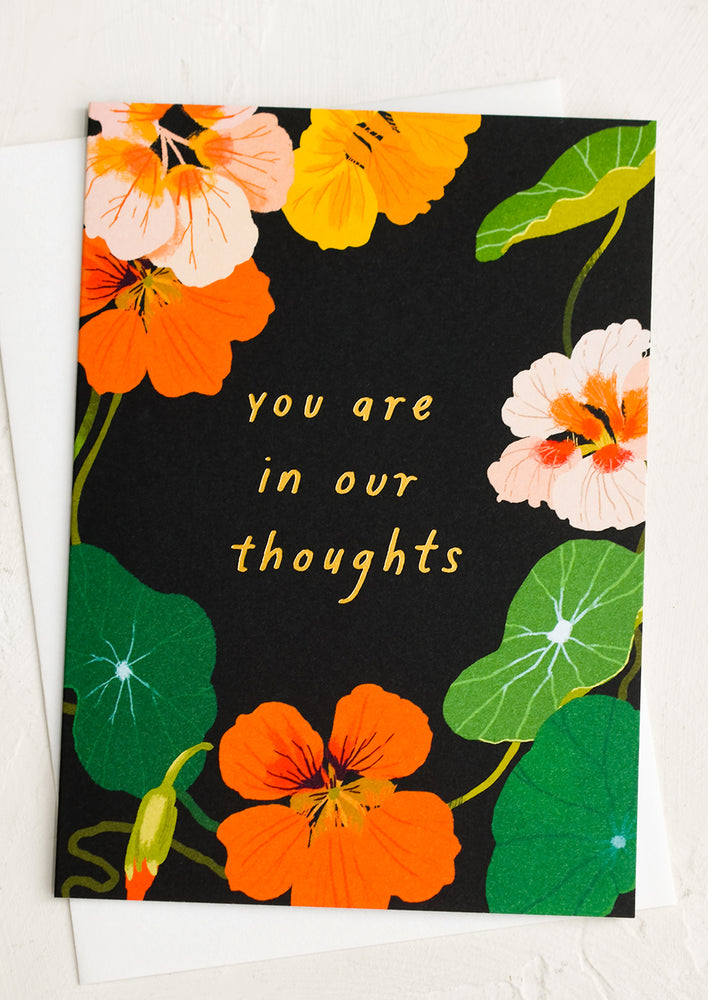 A nasturtium print card reading "You are in our thoughts".