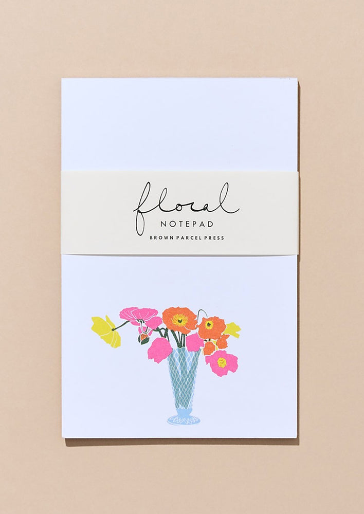 A white notepad with vase of neon poppies print.