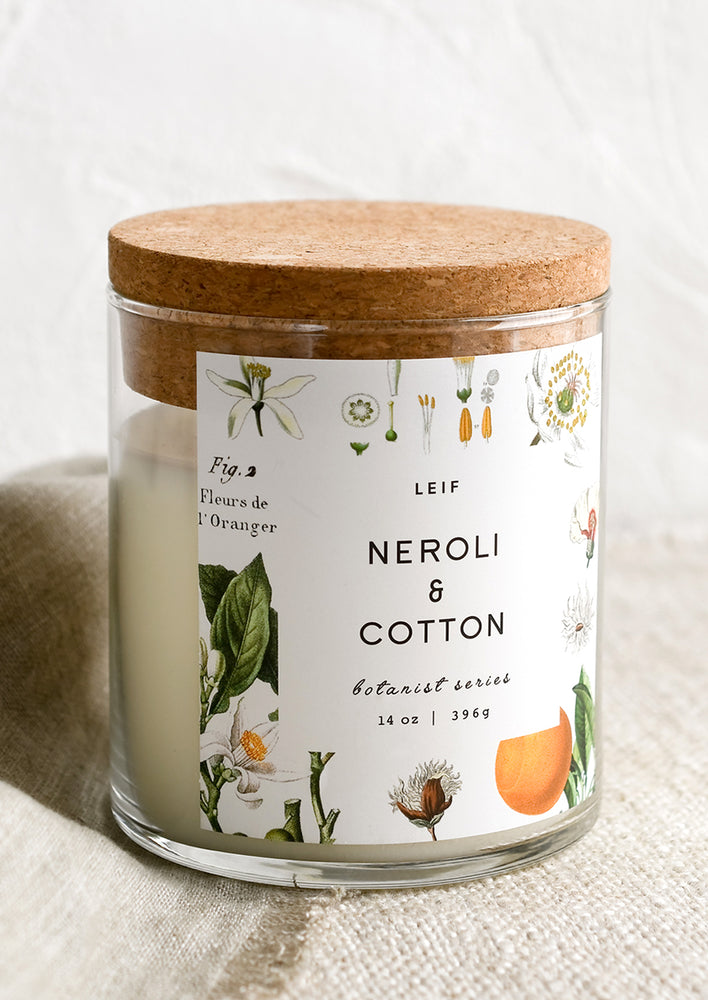 Neroli & Cotton: A glass candle with a cork lid and white botanical printed label reading "neroli and cotton".