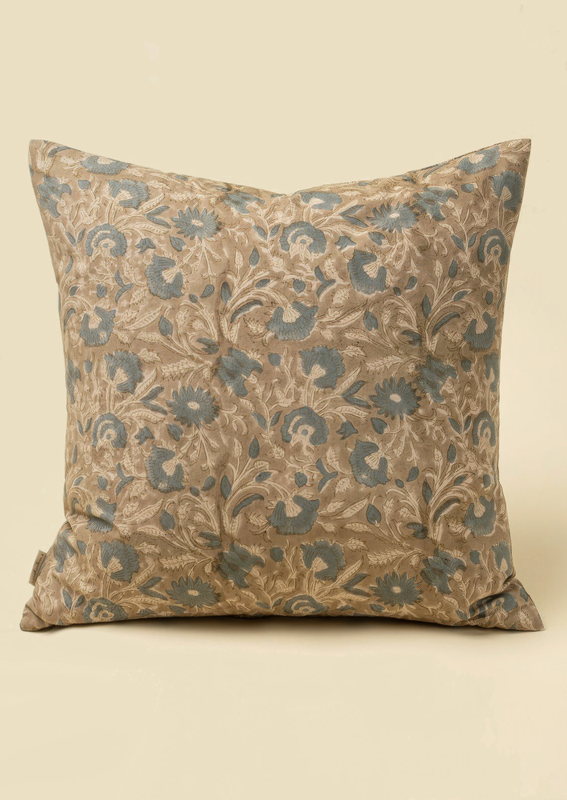 A block printed cotton throw pillow in taupe and dusty blue floral pattern.