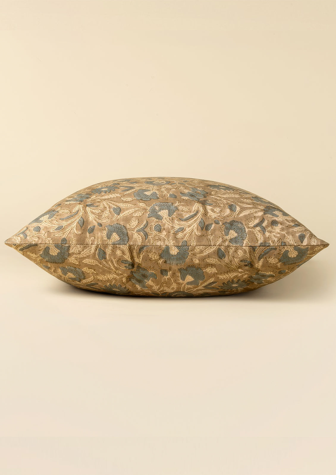 A block printed cotton throw pillow in taupe and dusty blue floral pattern.