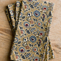1: A floral print napkin set in brown, indigo and red.