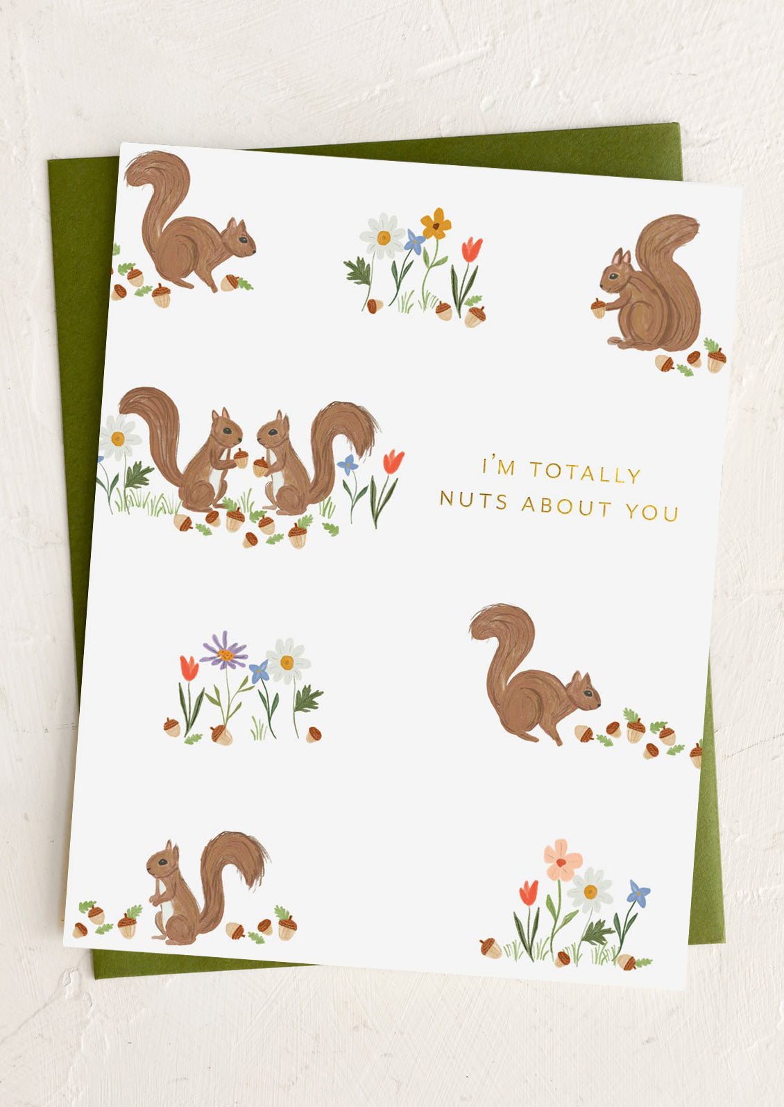 Greeting card with squirrels and flowers and text 'I'm totally nuts about you' on a white background.