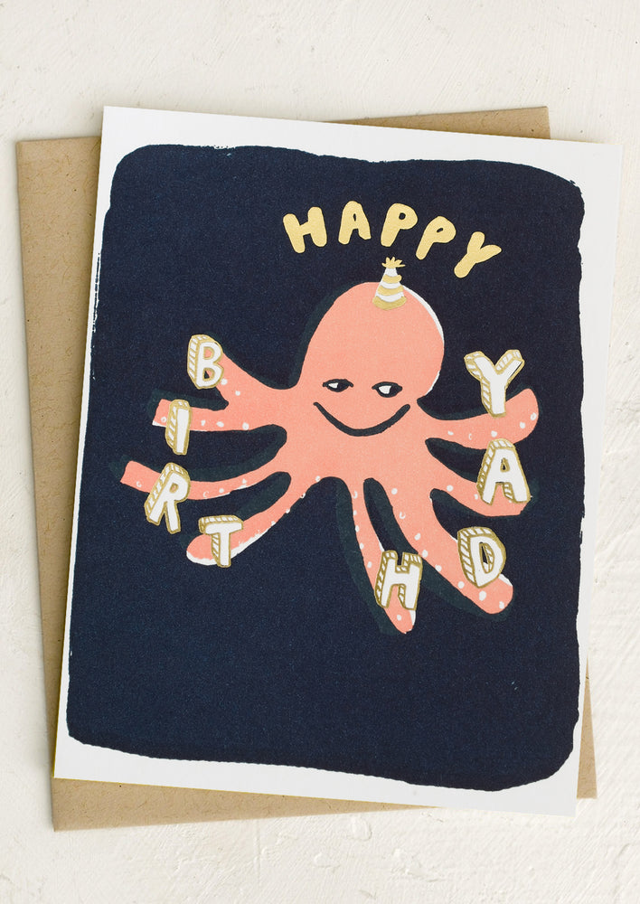 A card with peach octopus holding birthday letters.