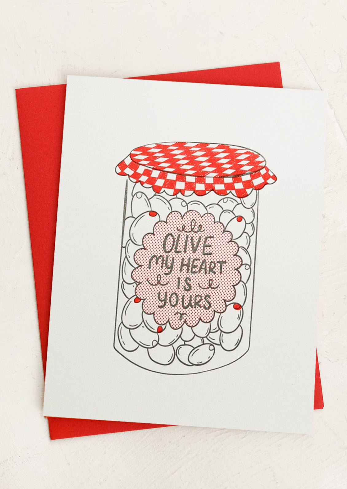 Card with an olive jar illustration and text 'Olive my heart is yours' on a red envelope.