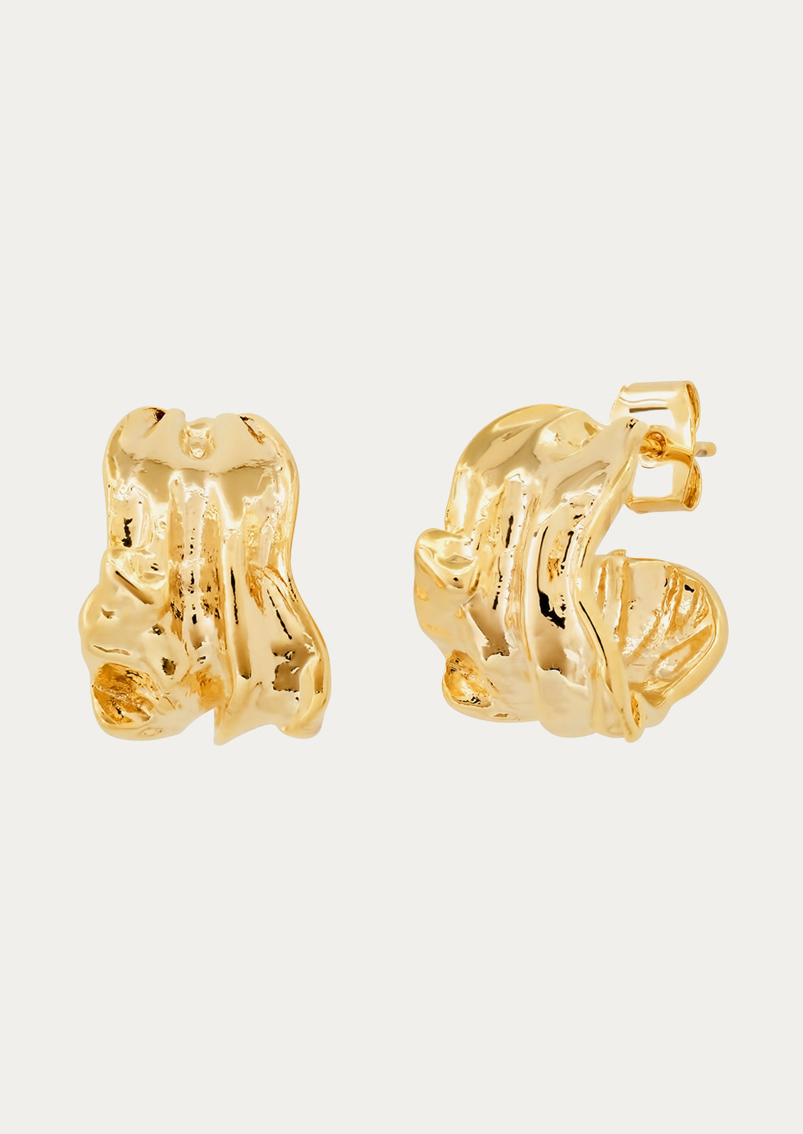 A pair of gold carved cuff earrings.