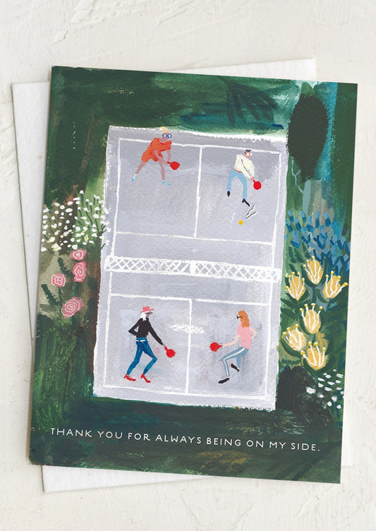 Greeting card with illustration of people playing badminton on a court, surrounded by nature, text reads "Thanks for always being on my side".