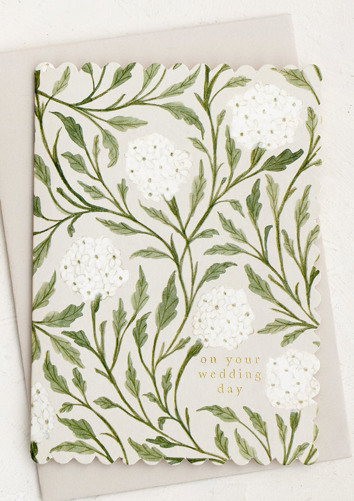 A scalloped edge floral print card reading "On your wedding day".