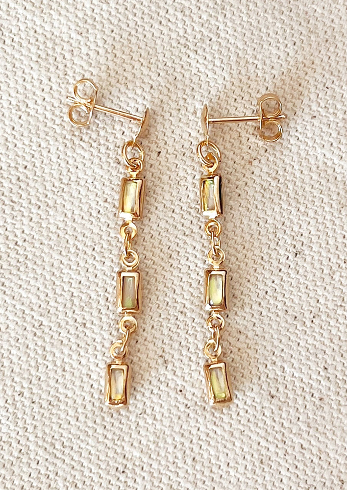 A pair of opal baguette drop earrings.