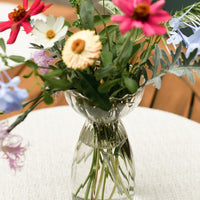 2: A glass vase with flowers.