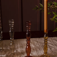 2: Assorted colors of optic glass candleholders with taper candles.