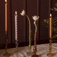 1: Assorted colors of optic glass candleholders with taper candles.