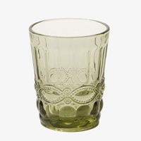 2: An olive green glass cup with vintage style embossed design.