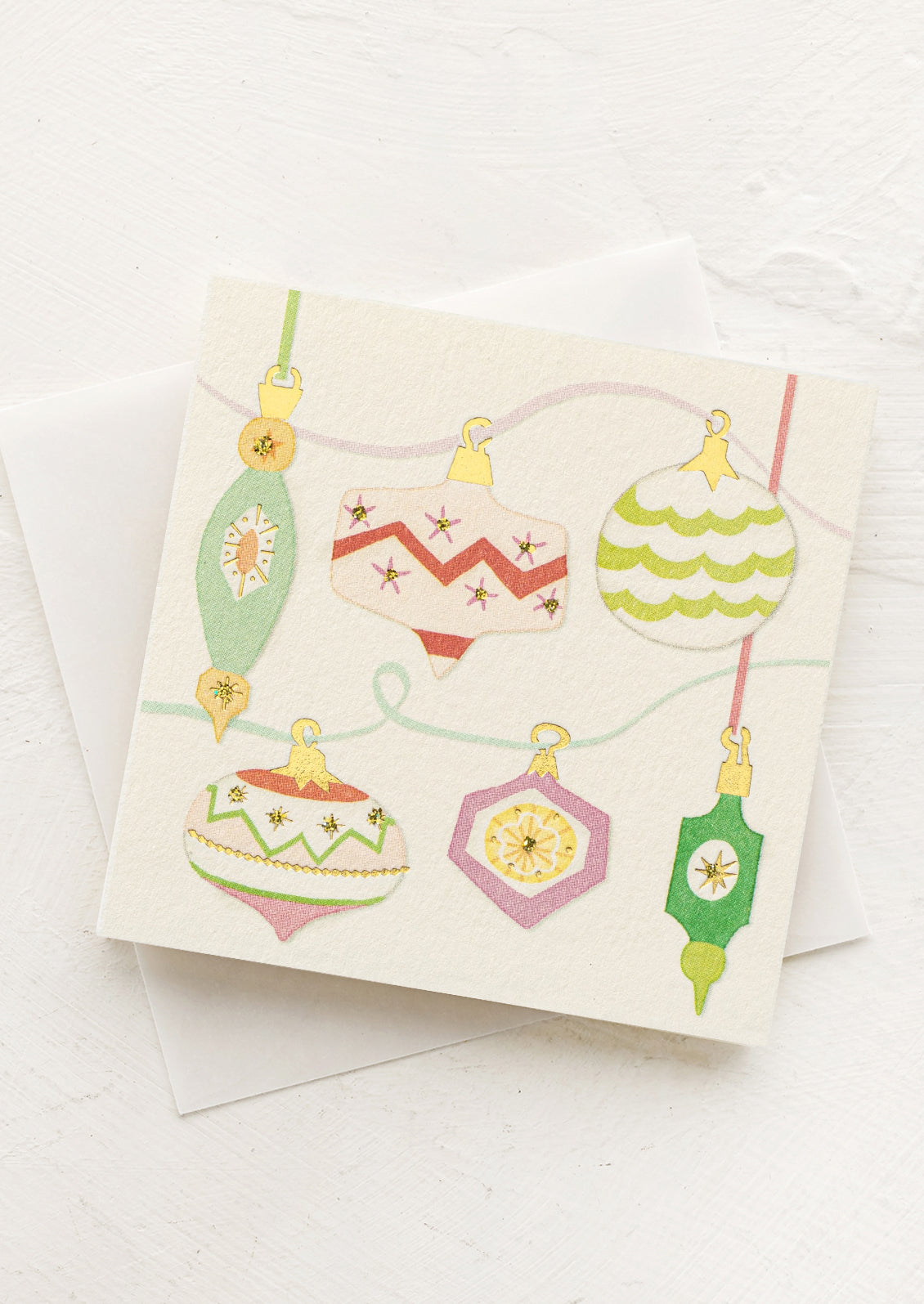 Greeting card with colorful Christmas ornament design on a white background
