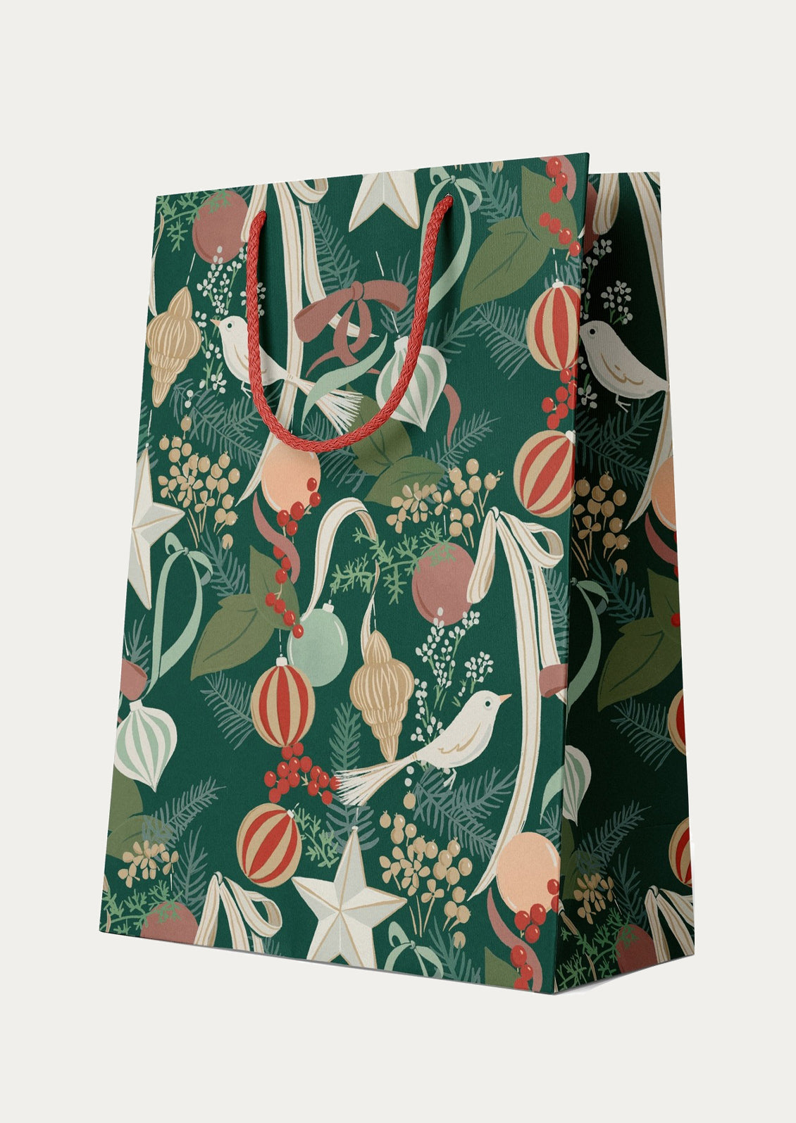 Gift bag with festive design featuring birds, stars, and ornaments on a green background.