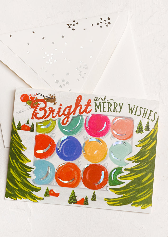 A card with illustration of ornament box, text reads "Bright and merry wishes".