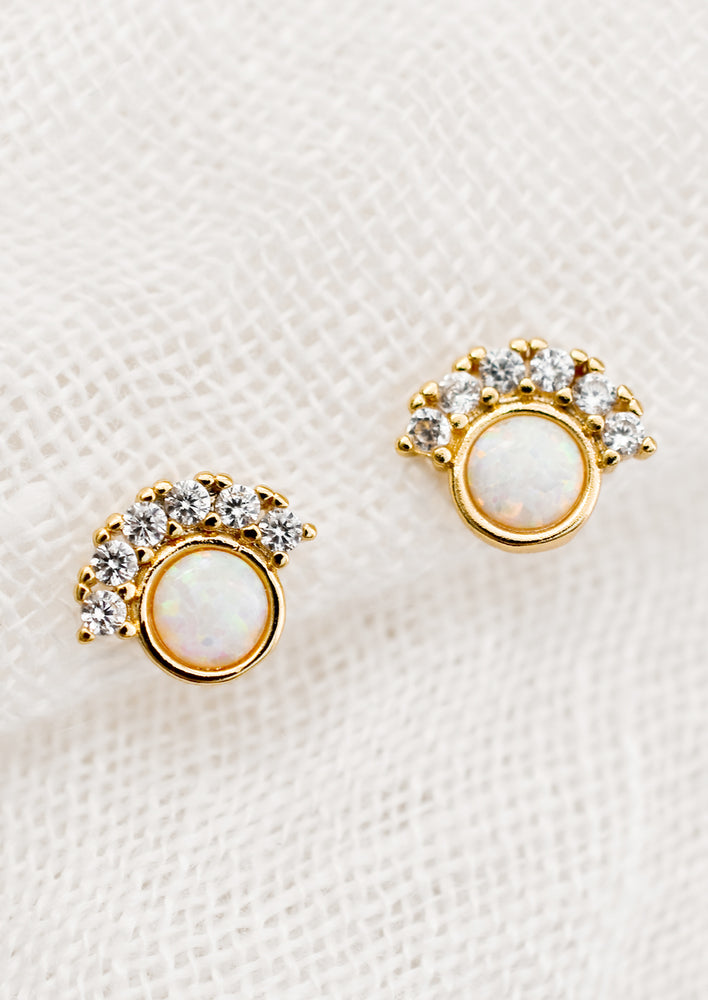 A pair of opal stud earrings with clear CZ pave detailing.