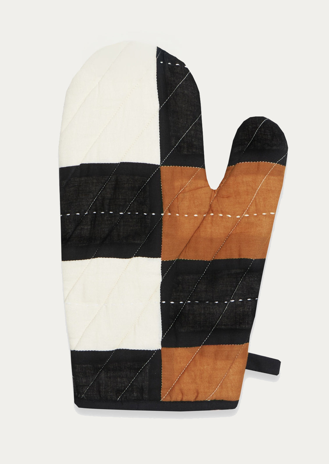 Multicolored quilted oven mitt in white, camel and black.